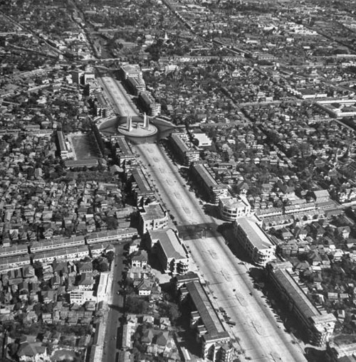 Looking north on Ratchadamnoen Avenue, pas the Democracy Monument, which was built in 1939. The road going diagonally downward on the bottom left of the picture is Khao San Road.