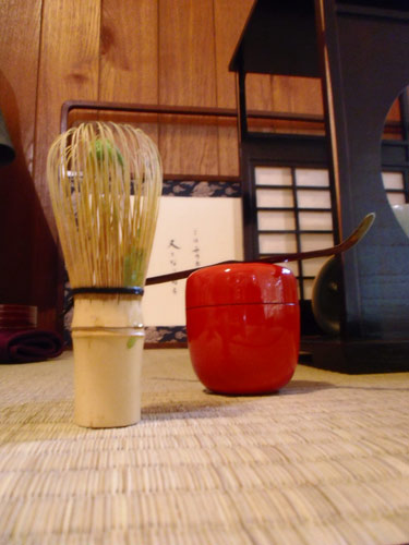 The whisk, on the left, and the tea container, made from Japanese lacquer. The whisk is made from a single piece of bamboo. Neat!