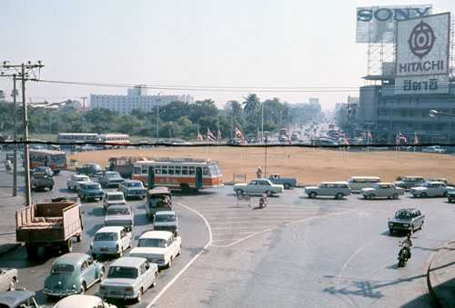 This is Siam Square in 1970, looking east up Rama I Road toward the beginning of Sukhumvit Road. The white building in the back left is one part of the old Siam Intercontinental Hotel.