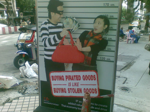 I saw this the other day about fifty feet away from Pat Pong, where a piracy raid recently went down. I like the HORRIFIED look on the woman's face at being offered pirated goods.
