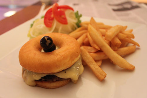 The Le Fenix donut burger. The olives and salad are a nice touch. It's like giving someone an extra Band-Aid after their leg's been cut off.