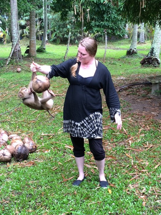 My sister playing the part of a tree while the monkey practices his coconut-gettin' skillz.