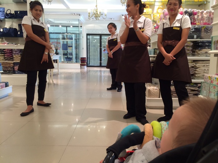 Sales girls ignoring customers to stare at a baby. The usual.